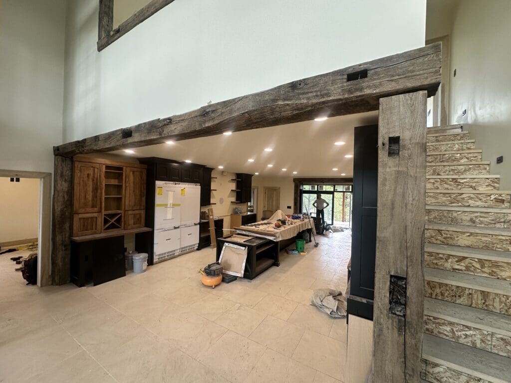 Custom reclaimed wood beam installation and handcrafted woodwork by JG Carpentry in Spearfish, SD featuring exposed structural beams and custom built-ins.