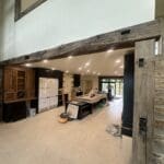 Custom reclaimed wood beam installation and handcrafted woodwork by JG Carpentry in Spearfish, SD featuring exposed structural beams and custom built-ins.