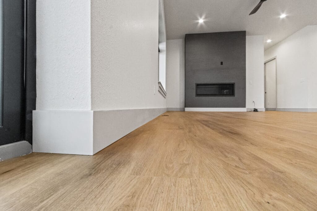 Custom residential trim carpentry in Spearfish, SD by JG Carpentry featuring modern baseboards, clean corner detailing, and luxury vinyl plank flooring.