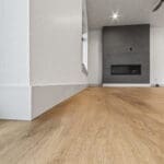 Custom residential trim carpentry in Spearfish, SD by JG Carpentry featuring modern baseboards, clean corner detailing, and luxury vinyl plank flooring.