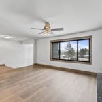 Completed full-home remodel in Spearfish, SD by JG Carpentry featuring updated hardwood flooring, modern fireplace, large picture window, and custom wood trim work.